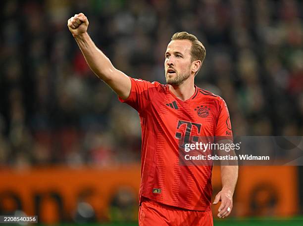 Harry Kane of Bayern Munich celebrates scoring his team's second goal during the Bundesliga match between FC Augsburg and FC Bayern München at...