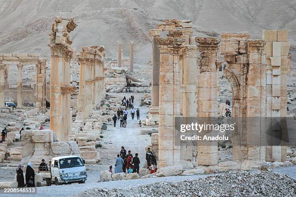 Syrians, including children, spend time among the ruins of the Palmyra, an ancient city, which was listed as a World Heritage Site by UNESCO in 1980...
