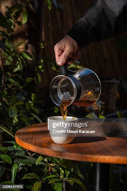 pouring coffee into a cup - caffeine stock pictures, royalty-free photos & images