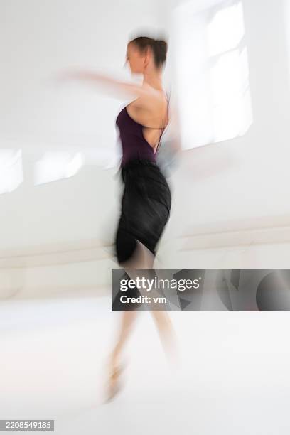 graceful caucasian female ballet dancer mid-pirouette - entertainment occupation stock pictures, royalty-free photos & images