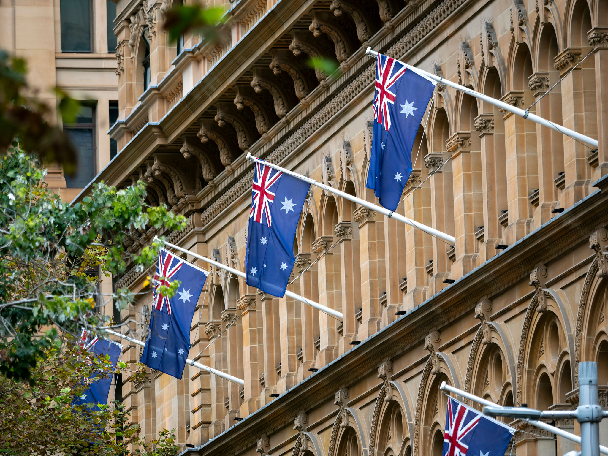 Australian flags in front of a building in Sydney Central Business District Australian flags in front of a building in Sydney Central Business District