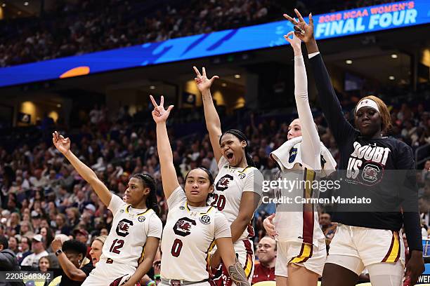 The South Carolina Gamecocks bench celebrates in the fourth quarter against the Texas Longhorns in the Final Four game of the NCAA Women's Basketball...