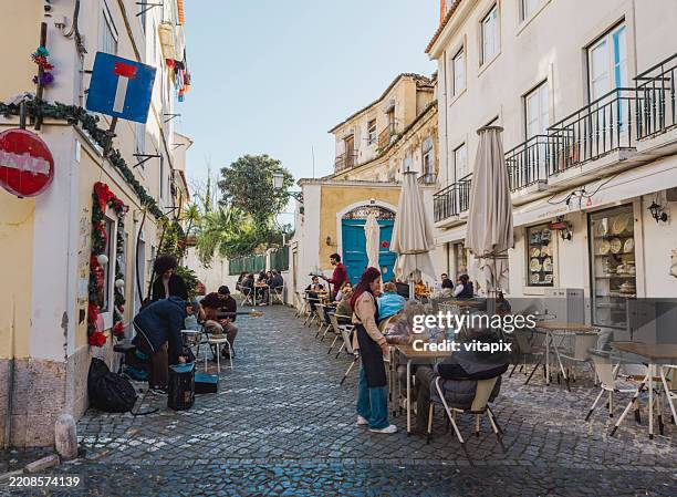 outdoor cafã© amid cobblestone streets and festive decorations - outdoor dining stock pictures, royalty-free photos & images