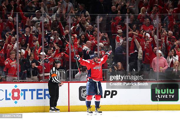 Alex Ovechkin of the Washington Capitals celebrates with teammates after scoring his 894th career goal in the third period against the Chicago...