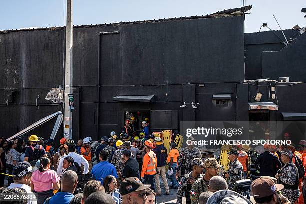 Personnel of Civil Defence and firefighters inspect the Jet Set nightclub after the collapse of its roof, in Santo Domingo, on April 8, 2025. At...