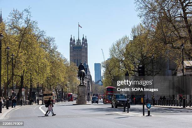 Quiet early afternoon on Whitehall in London. The Palace of Westminster tallest tower called Victoria Tower visible at the distance. Whitehall is a...