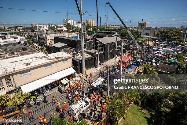 Personnel from civil defense and firefighters work at the Jet Set nightclub following the collapse of its roof in Santo Domingo on April 8, 2025....