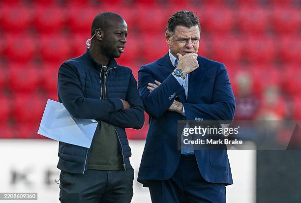 Carl Veart coach of Adelaide United with commentator Bruce Djite during the round 25 A-League Men match between Adelaide United and Sydney FC at...