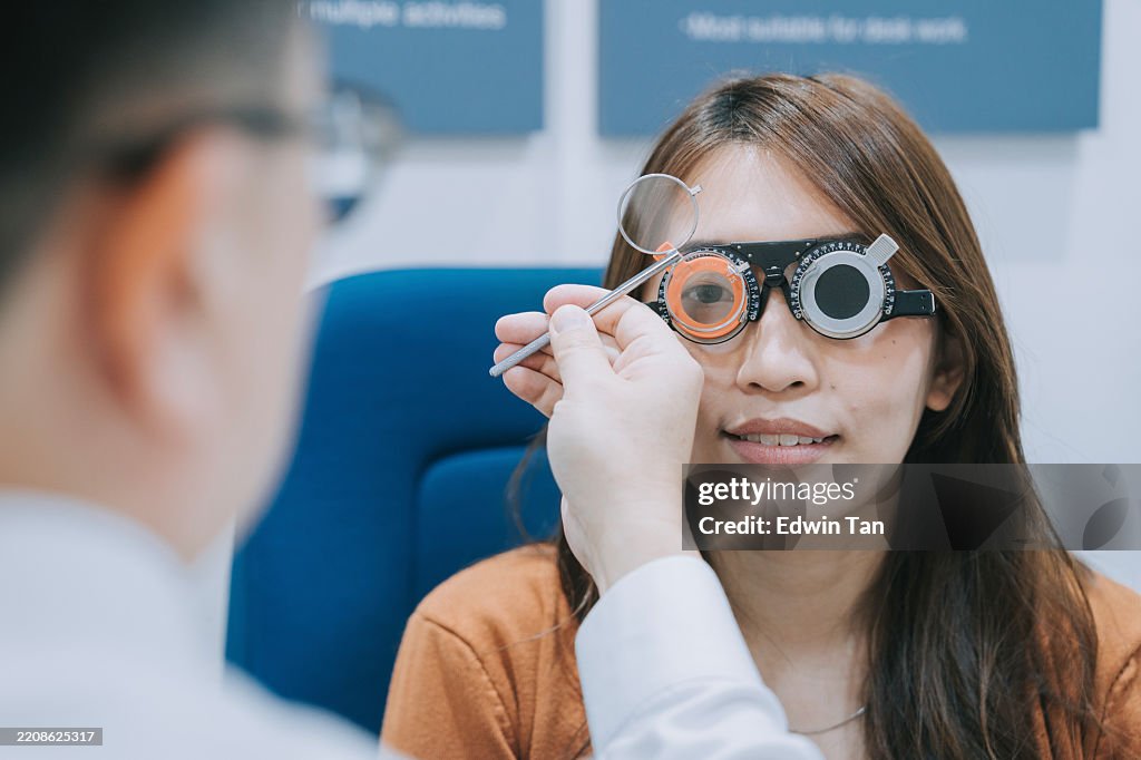 Asian chinese woman patient checking eyesight in ophthalmological clinic