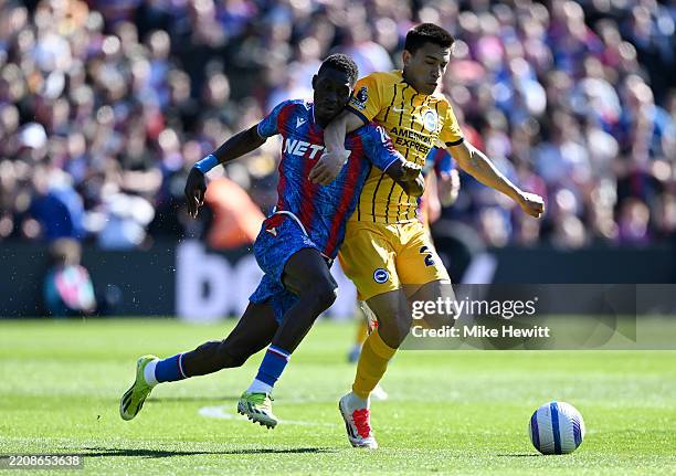 Ismaila Sarr of Crystal Palace battles for possession with Diego Gomez of Brighton & Hove Albion during the Premier League match between Crystal...