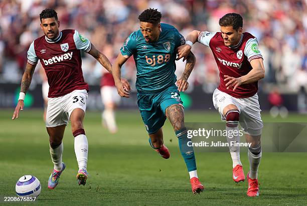 Daniel Jebbison of AFC Bournemouth is challenged by Konstantinos Mavropanos of West Ham United whilst under pressure from Emerson Palmieri of West...