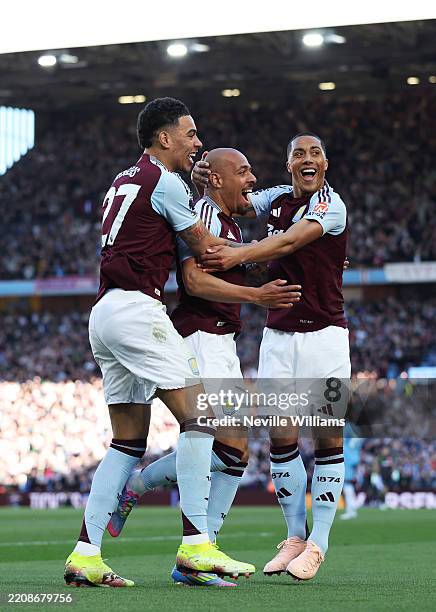 Donyell Malen of Aston Villa celebrates scoring his team's second goal with teammates Morgan Rogers and Youri Tielemans during the Premier League...