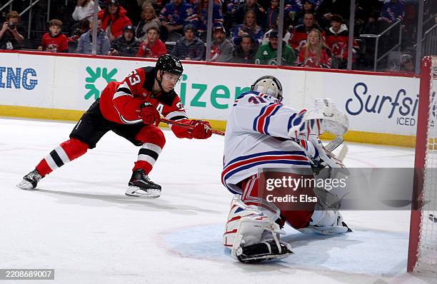 Jesper Bratt of the New Jersey Devils scores a goal during the second period as Igor Shesterkin of the New York Rangers is unable to make the save at...