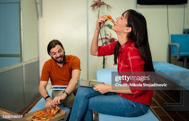 friends talking while eating at a bowling club - bowling alley stock pictures, royalty-free photos & images