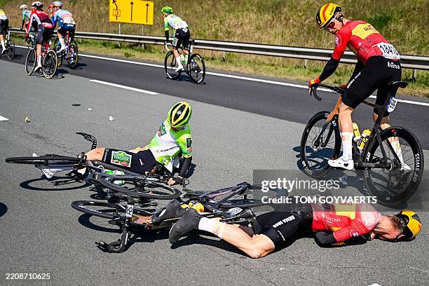 Norway's Jonas Iversby Hvideberg of Uno-X Mobility lies injured on the road with others after a crash during the men's race of the 113th edition of...