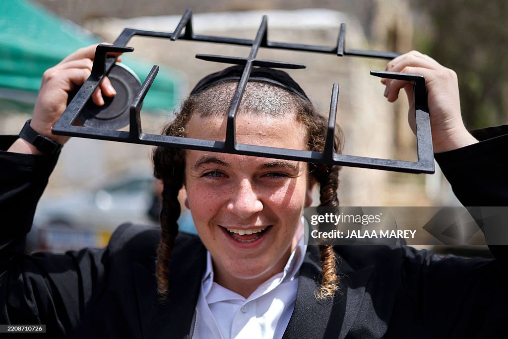 Middle Part Jew An ultra-Orthodox Jewish boy holds parts of a hob that will be dipped ...