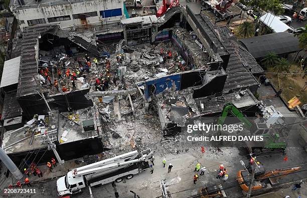Aerial view shows rescue teams working at the Jet Set nightclub a day after the collapse of its roof in Santo Domingo on April 9, 2025. Rescuers...