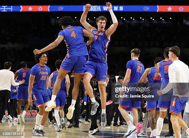 Micah Handlogten and Sam Alexis of the Florida Gators celebrate after the second half in the Final Four game of the NCAA Men's Basketball Tournament...
