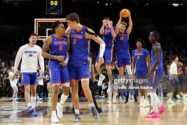 Will Richard and Micah Handlogten of the Florida Gators celebrate after defeating the Auburn Tigers in the Final Four game of the NCAA Men's...