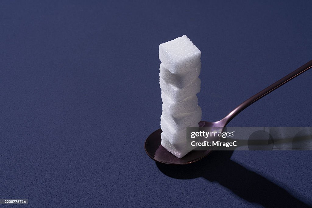 Sugar Cubes Stack High in Spoon