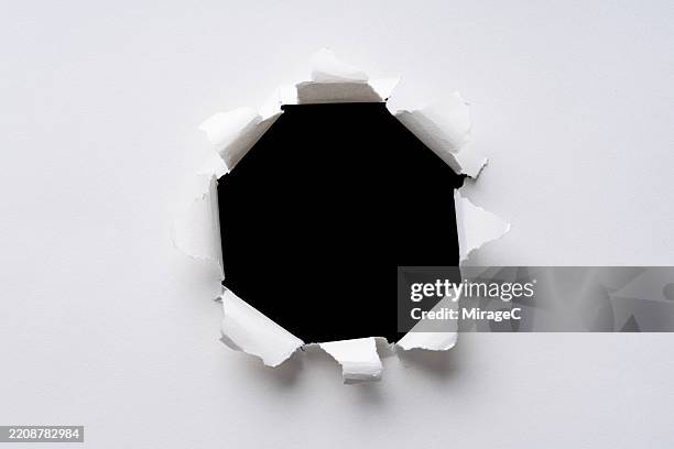 circular bullet hole in white paper - hole stock pictures, royalty-free photos & images