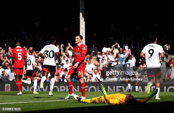 Andrew Robertson and Caoimhin Kelleher of Liverpool look dejected after Alex Iwobi of Fulham scores his team's second goal during the Premier League...