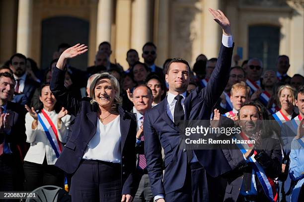 Marine Le Pen and Jordan Bardella wave to the crowd after delivering a speech on April 6, 2025 in Paris, France. French far-right leader Marine Le...