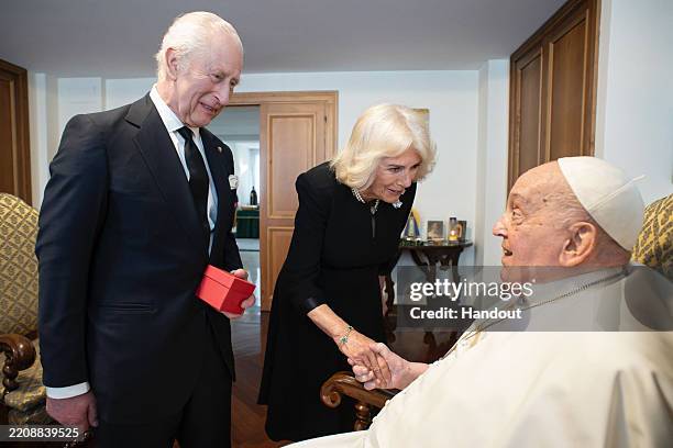 In this handout image supplied by the Vatican on April 10, King Charles III and Queen Camilla meet Pope Francis during day three of their State visit...