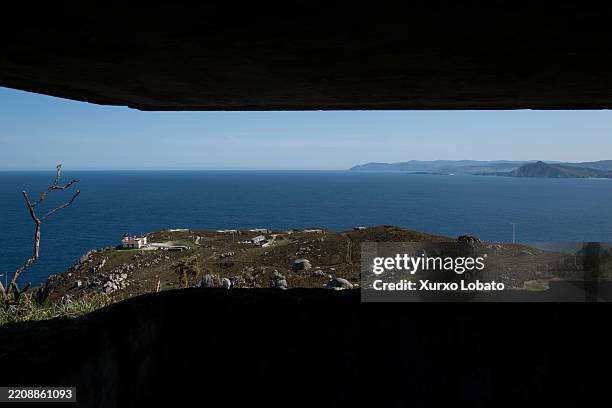 View through an abandoned Spanish army bunker of the Cape Prior cliffs and the lighthouse.Located in the Rias Altas region,seen on APRIL 6 Ferrol,...