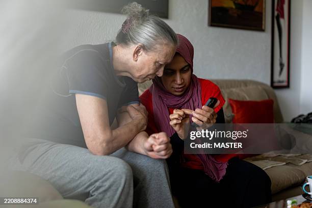 middle aged and senior woman with smartphone - türkei stock-fotos und bilder