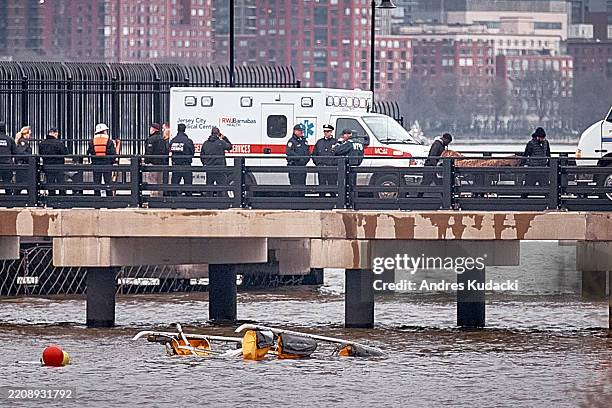 The bodies of victims are transported after a helicopter crashed in the Hudson River on April 10, 2025 in Jersey City, New Jersey. Six people are...