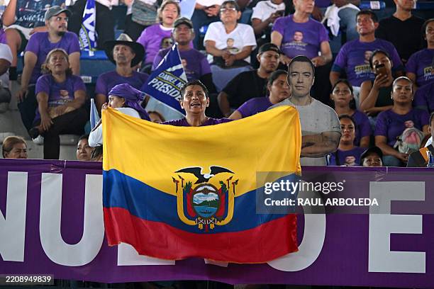 Supporter of Ecuador's President and presidential candidate for the Acción Democrática Nacional party , Daniel Noboa, waves an Ecuadorian flag as she...