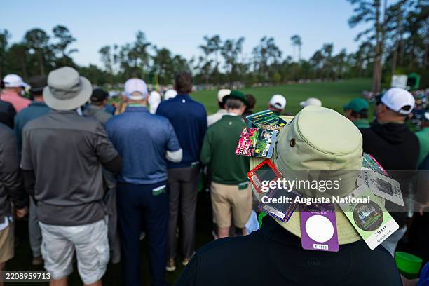 Patron is seen with badges affixed to their hat during the first round of the Masters at Augusta National Golf Club, Thursday, April 10, 2025.