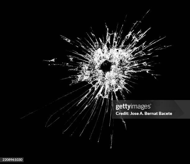 bullet hole pierces and breaks tinted car window. - bullet hole stock pictures, royalty-free photos & images