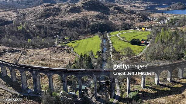 In this aerial view - a 1950s diesel locomotive pulls the Jacobite carriages in place of the Jacobite which was unable to run due to the high risk of...
