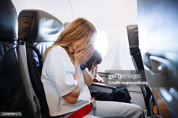 airsickness. women feels very bad on the plane - brechreiz stock-fotos und bilder