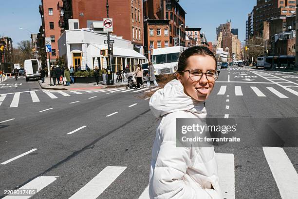 teenage girl sticking out tongue - west village stock pictures, royalty-free photos & images