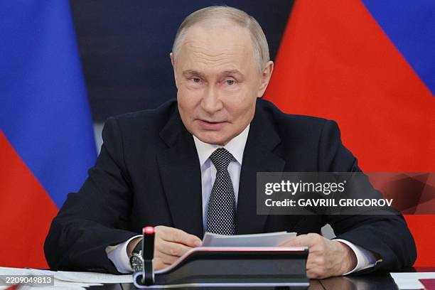 In this pool photograph distributed by the Russian state agency Sputnik, Russian President Vladimir Putin chairs a meeting on the Navy development in...
