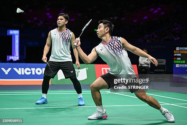 Malaysia's Goh Sze Fei and Nur Izzuddin play a point during the men's doubles quarterfinal match against China's Chen Boyang and Liu Yi at the...
