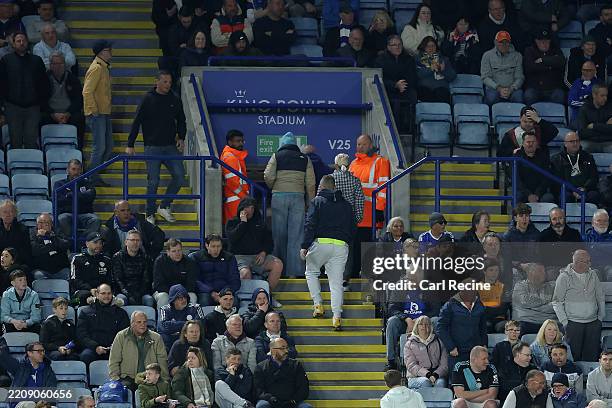 Fans of Leicester City make their way to the exit shortly after Harvey Barnes of Newcastle United scores his team's third goal during the Premier...