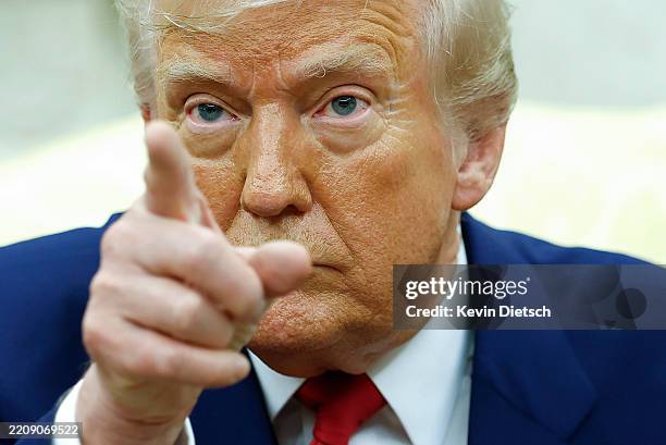President Donald Trump answers a reporters question during a meeting with Israeli Prime Minister Benjamin in the Oval Office of the White House on...