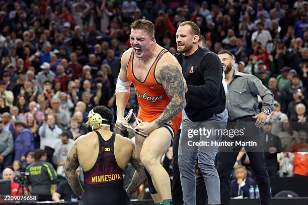 Wyatt Hendrickson of the Oklahoma State Cowboys celebrates with head coach David Taylor after winning the 285 pound title during the 2025 NCAA...
