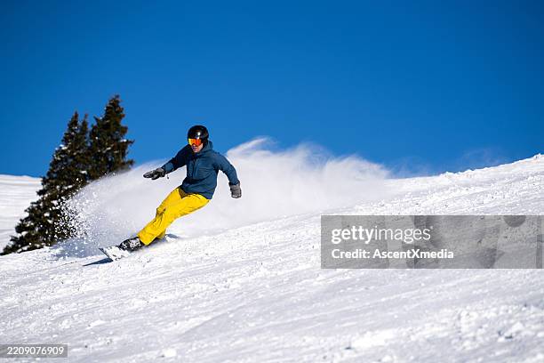 snowboarder descends mountain, swiss alps - professional skier stock pictures, royalty-free photos & images