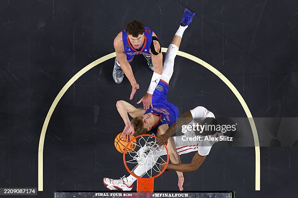 Ja'Vier Francis of the Houston Cougars dunks the ball against Thomas Haugh of the Florida Gators during the first half in the National Championship...