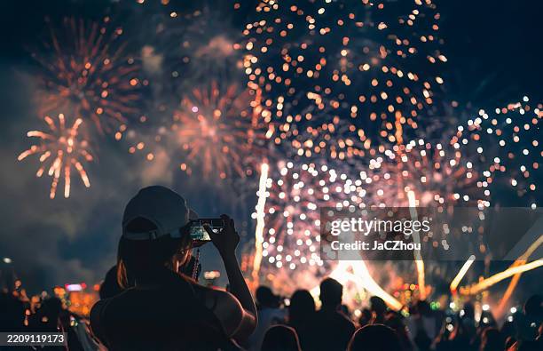 girl watching a firework display - raket bildbanksfoton och bilder