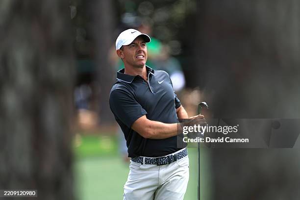 Rory McIlroy of Northern Ireland watches his second shot on the 18th hole during the second round of the 2025 Masters Tournament at Augusta National...