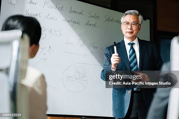 portrait of senior asian businessman in meeting. - old chinese man stock pictures, royalty-free photos & images