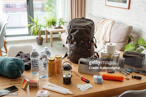 emergency equipment to face crisis and disasters. water, food, first aid kit, tools and another items needed to survive - food state stock pictures, royalty-free photos & images