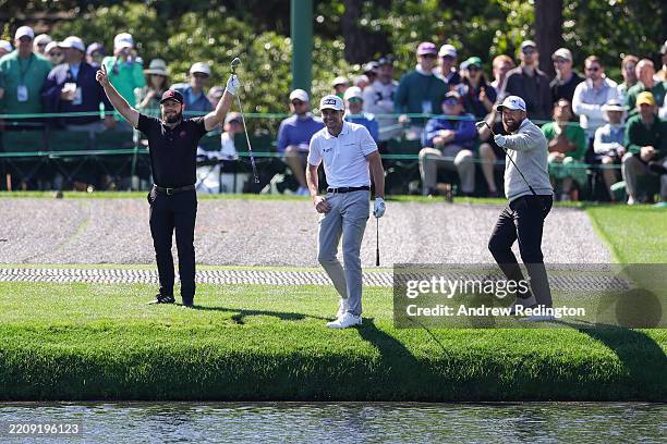 Tyrrell Hatton of England, Laurie Canter of England and Shane Lowry of Ireland react after skipping balls across the water on the 16th hole during a...