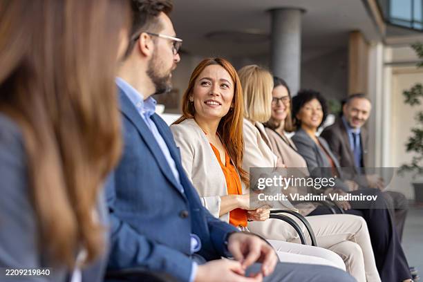 engaged and smiling audience in a creative setting - attending stock pictures, royalty-free photos & images
